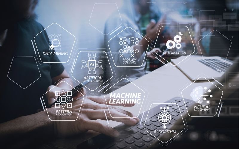 Hands on a laptop with AI and automation concepts overlaid